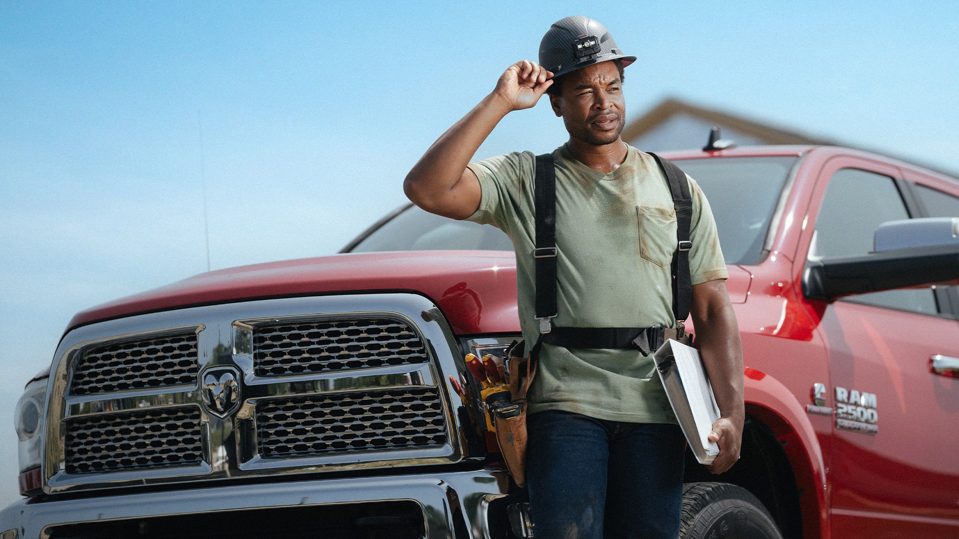 Cummins worker with a RAM truck behind him