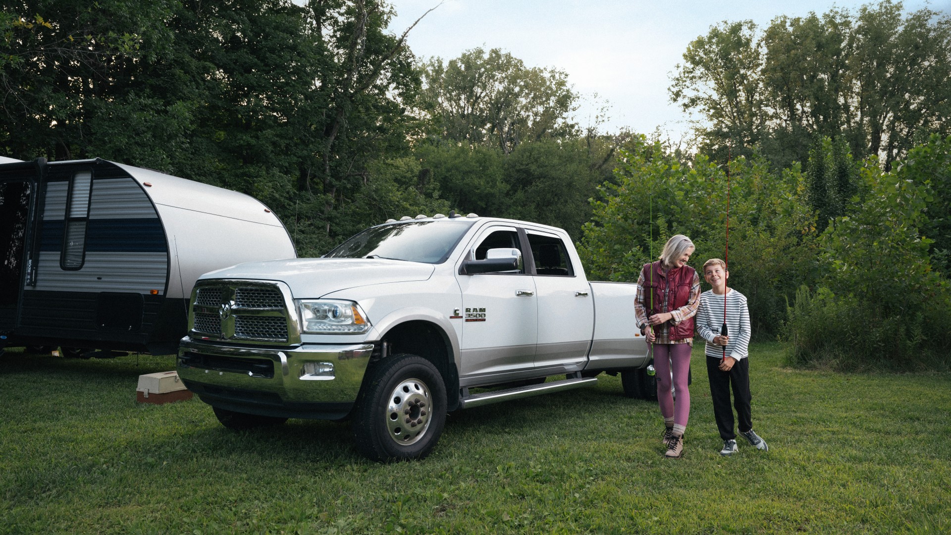 Family preparing to go fishing next to their RAM truck